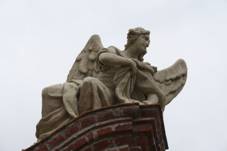 Statue of girl angel at Gate of cemetery in Budi�ov.jpg